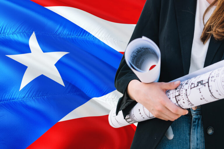 Architect woman holding blueprint against Puerto Rico waving flag background.