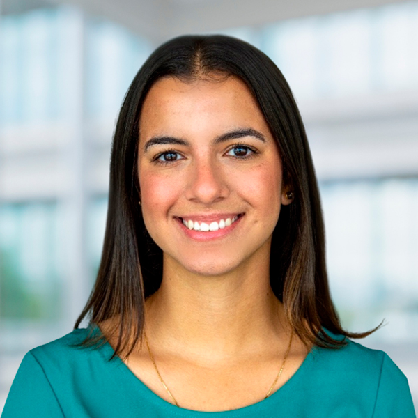 Headshot of a white woman with a aquamarine shirt smiling